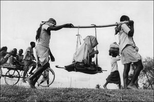 two-men-carrying-woman-1947